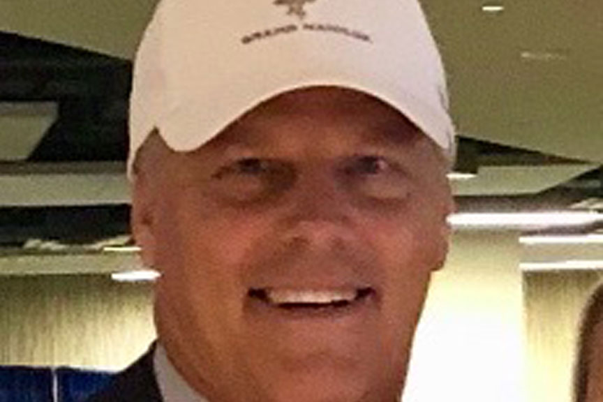 man smiling wearing white hat