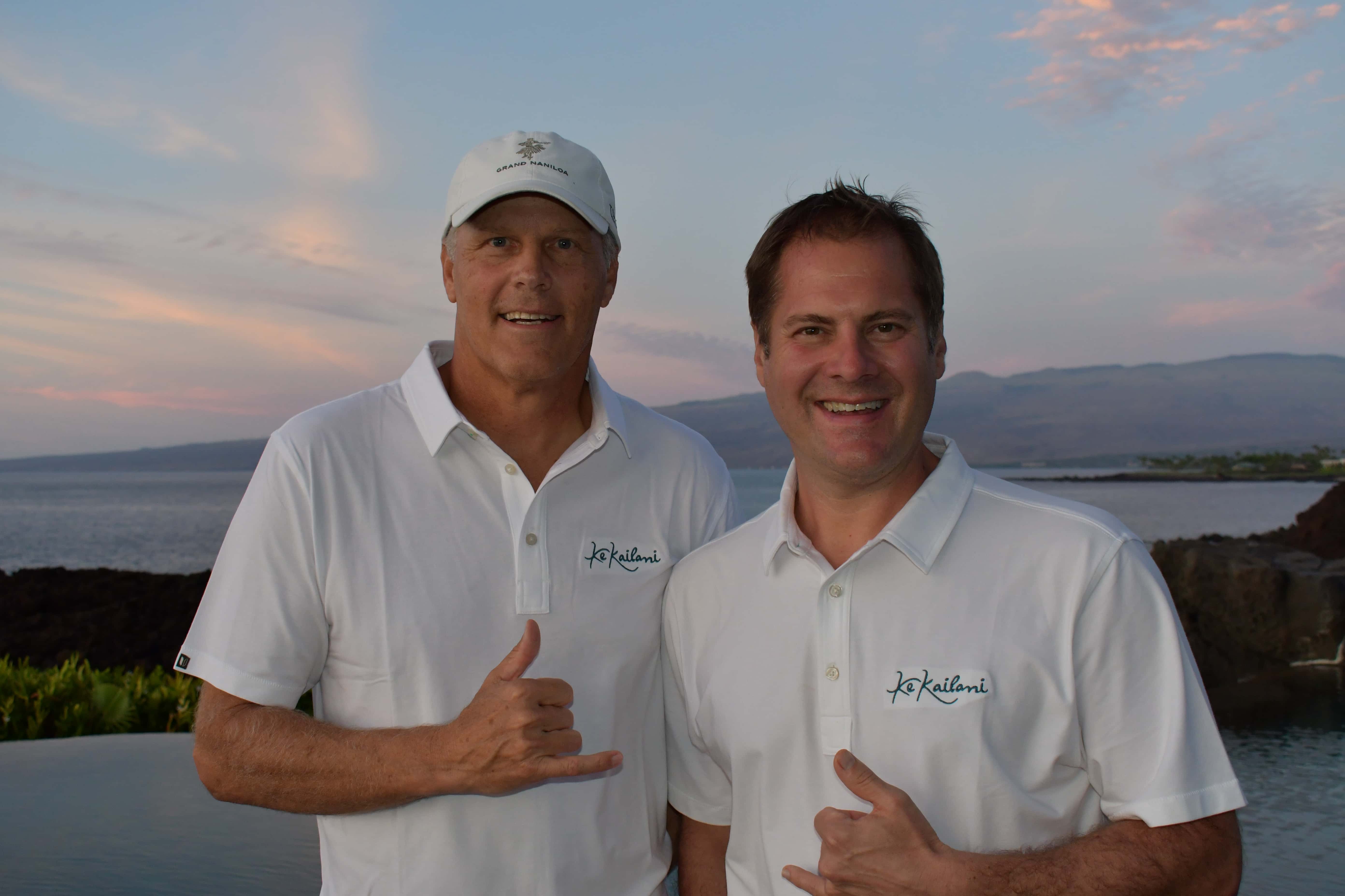 two men smiling in white shirts